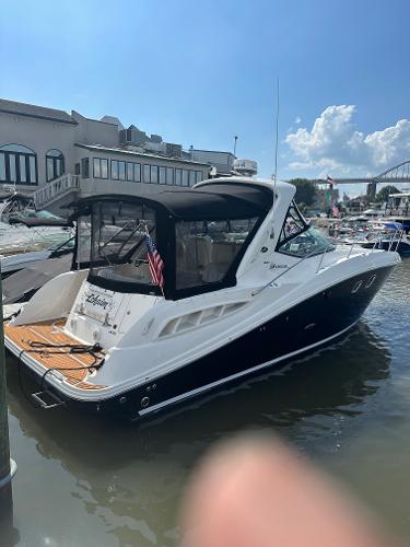 Sea Ray 330 Sundancer 2008 Sea Ray 330 Sundancer docked at marina under clear blue sky.