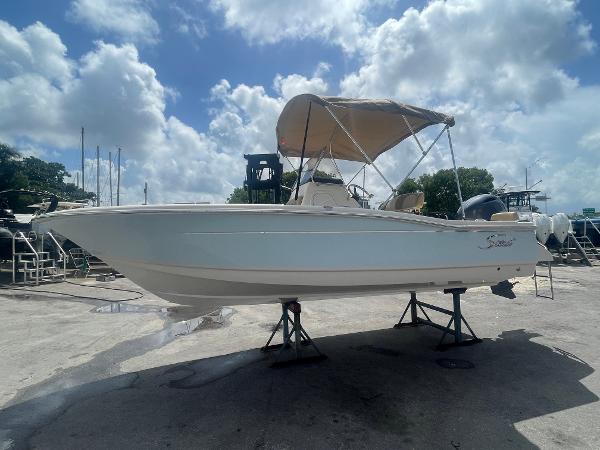 Scout 195 Sportfish 2025 Scout 195 Sportfish boat with canopy on dry dock.
