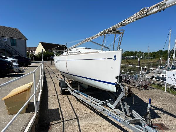 Beneteau First 211 2004 Beneteau First 211 sailboat on trailer, dockside, under clear blue sky.