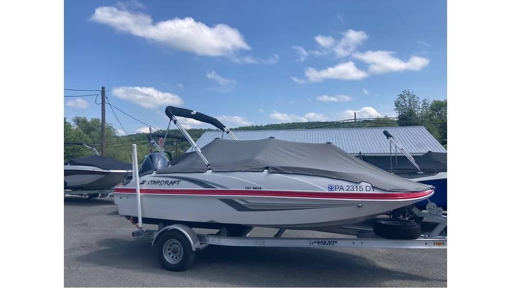 Starcraft MDX 191 O/B 2019 Starcraft MDX 191 O/B boat on trailer, covered, under blue sky.