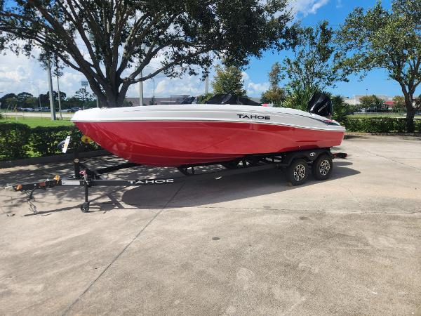 Tahoe T21 2025 Tahoe T21 boat on trailer, red and white design, parked outdoors.