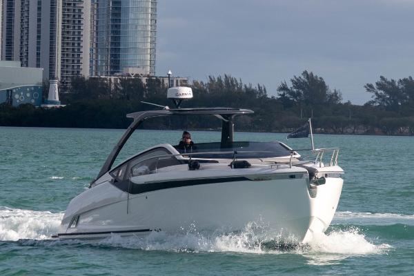 Fairline F//Line 33 Outboard 2023 Fairline F//Line 33 Outboard cruising on water near cityscape.
