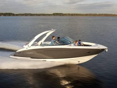 Regal 2800 2019 Regal 2800 boat cruising on a calm lake at sunset.