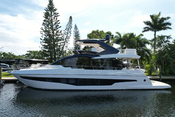 Astondoa 66 Flybridge 2024 Astondoa 66 Flybridge yacht docked by palm trees.