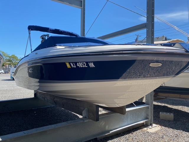 Sea Ray SPX 210 2022 Sea Ray SPX 210 boat on a storage rack under clear blue sky.