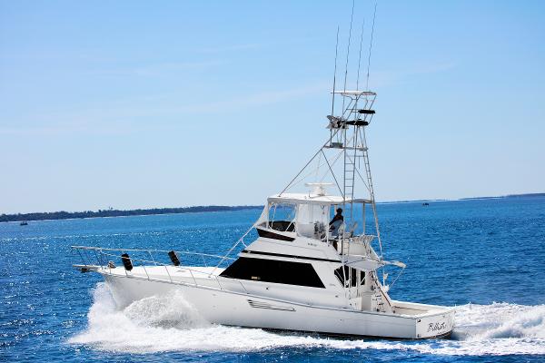 Viking 48 Convertible 1990 Viking 48 Convertible yacht cruising on open blue sea.