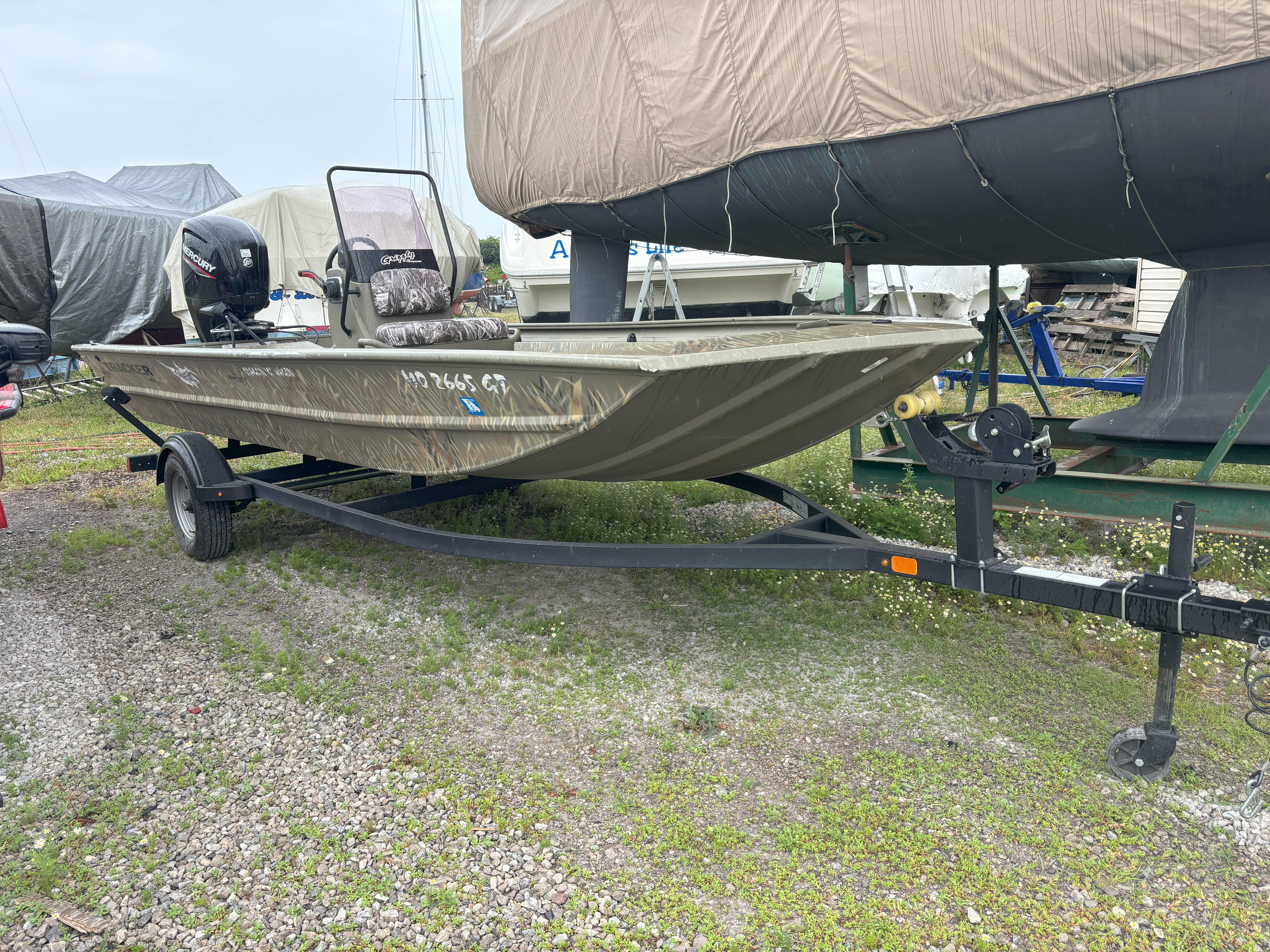 Tracker Grizzly 1860 CC 2022 Tracker Grizzly 1860 CC boat on trailer, parked outdoors.