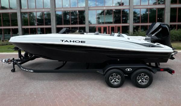 Tahoe T21 2025 Tahoe T21 boat on trailer, sleek design, parked outdoors.