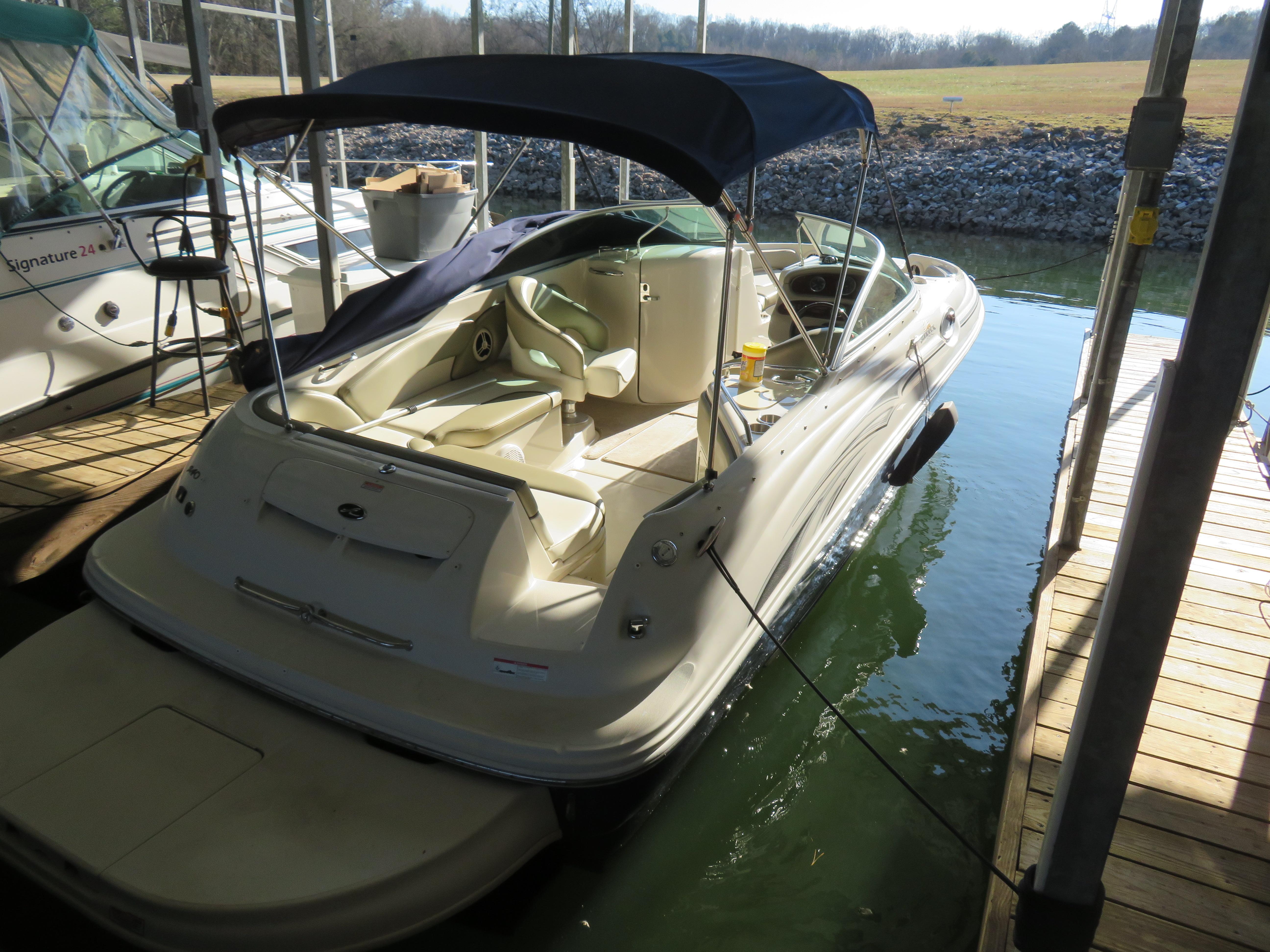 Sea Ray 240 Sundeck 2006 Sea Ray 240 Sundeck boat docked with canopy, interior view.