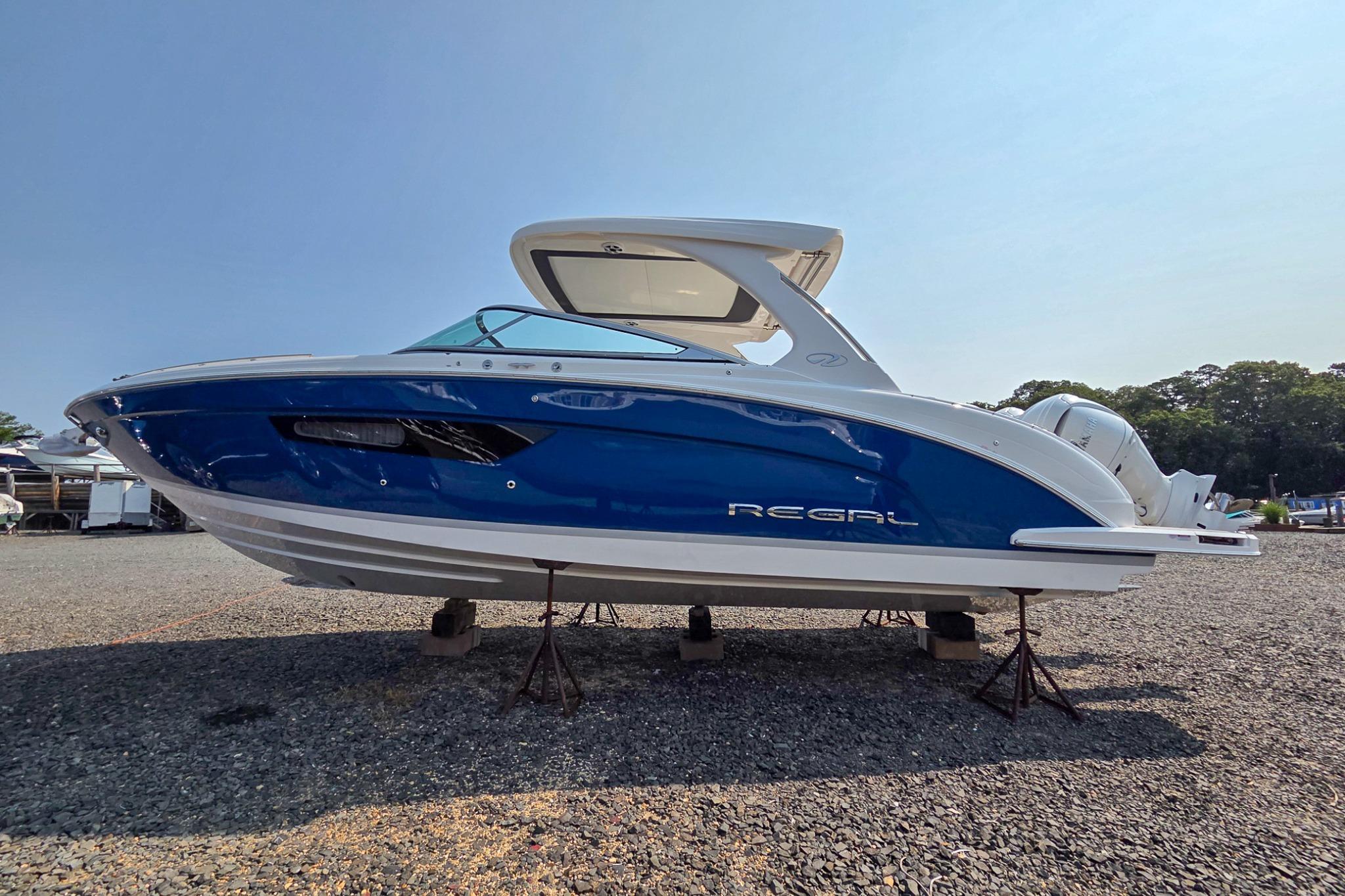 Regal 33 OBX 2026 Regal 33 OBX boat with sleek blue and white design on display.