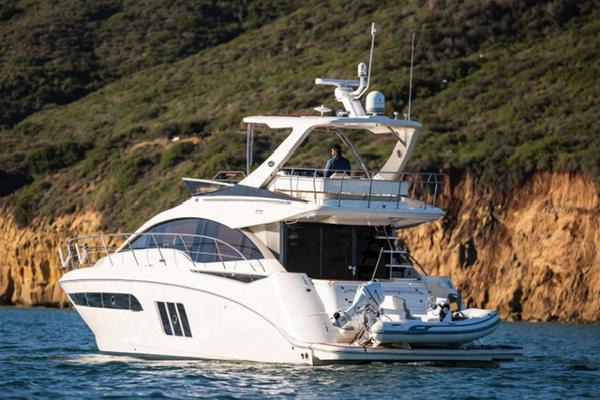 Sea Ray 510 Fly 2015 Sea Ray 510 Fly yacht cruising near rocky coastline.
