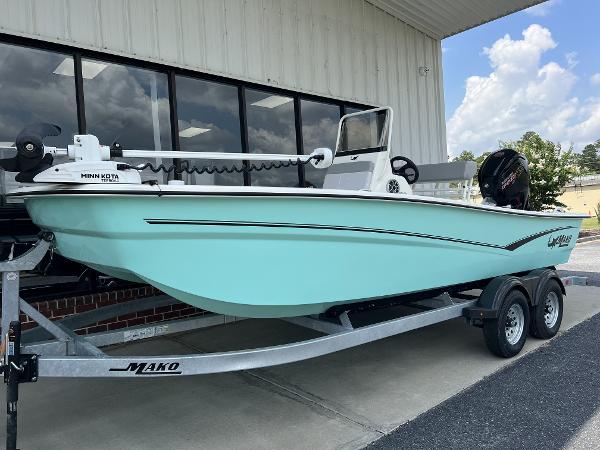 Mako Pro Skiff 19 CC 2024 Mako Pro Skiff 19 CC on trailer, light blue hull, parked outside.