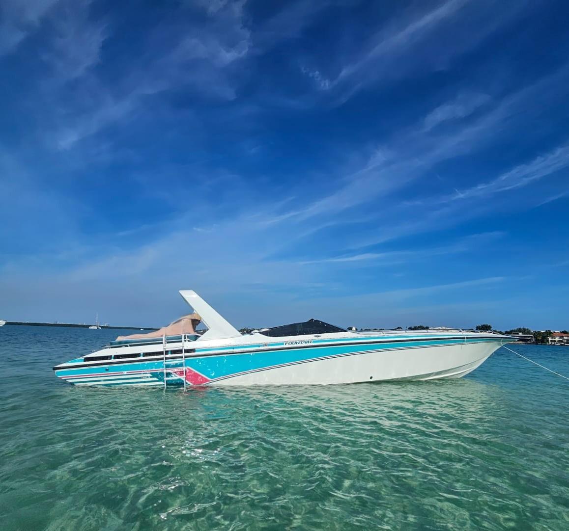 Fountain 38 Fever 1991 Fountain 38 Fever boat on clear water under a blue sky.