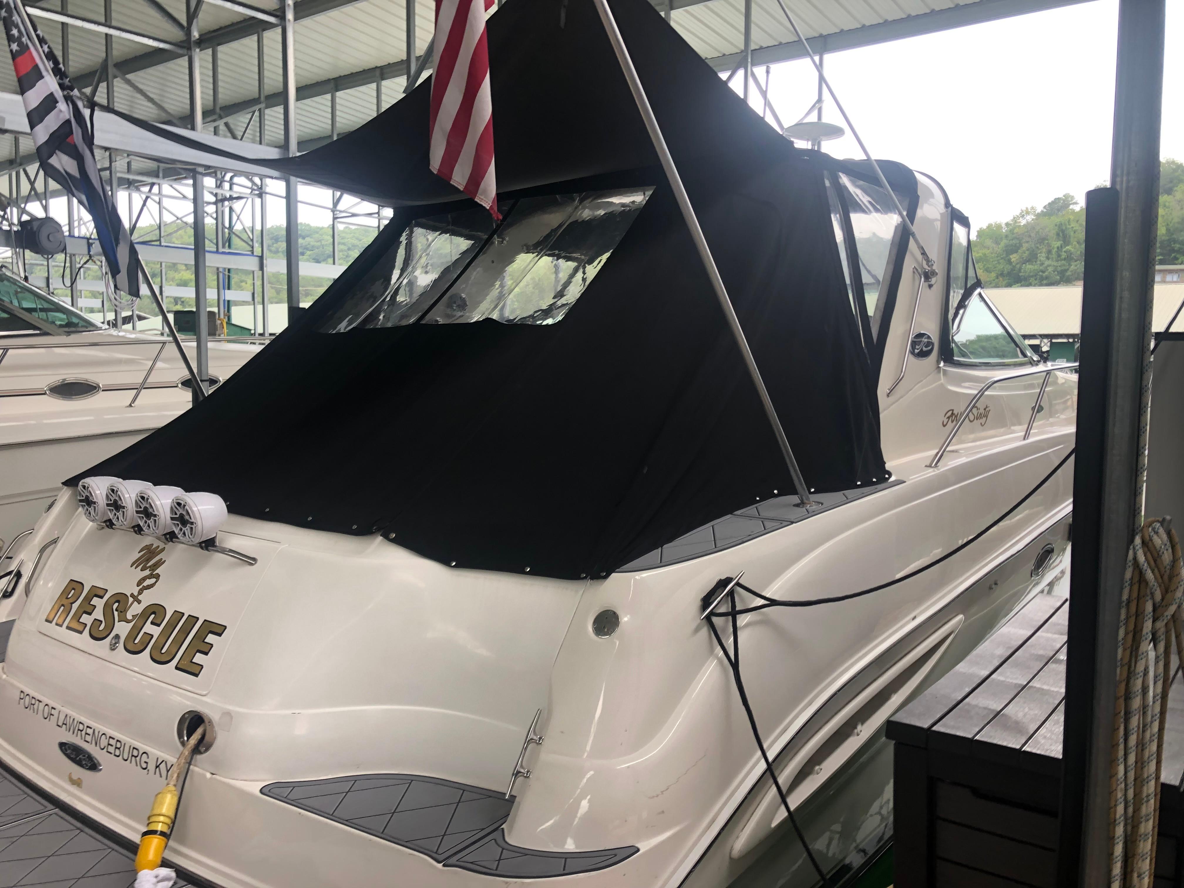 Sea Ray 460 Sundancer 1999 Sea Ray 460 Sundancer docked, featuring black canopy and American flag.