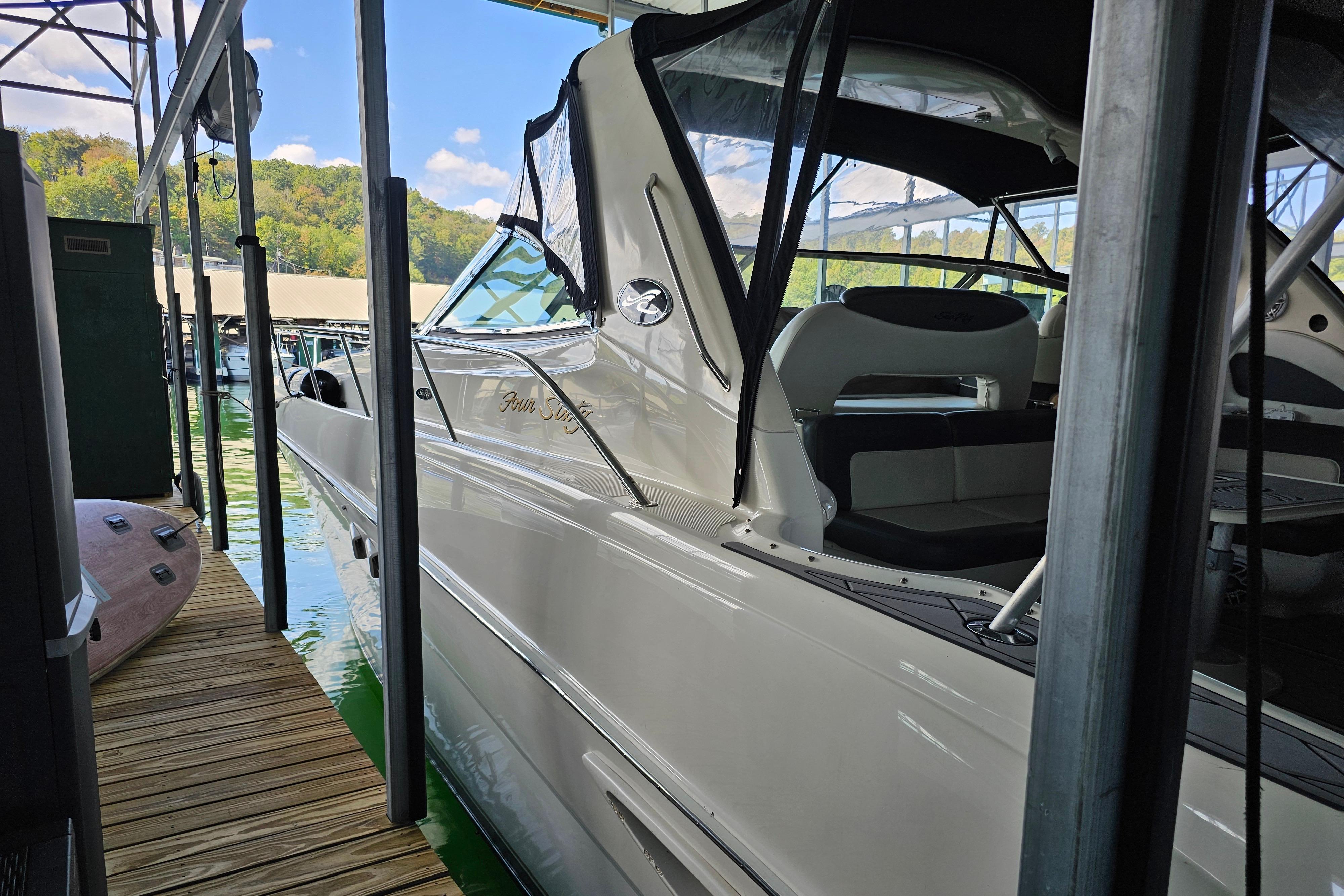 Sea Ray 460 Sundancer 1999 Sea Ray 460 Sundancer docked in a marina, showcasing sleek design and luxury seating.