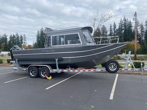 Spartan 240 Maximus 2025 Spartan 240 Maximus boat on trailer in parking lot.