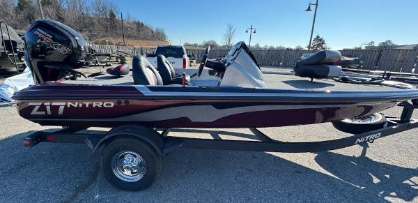 Nitro Z17 2025 Nitro Z17 boat on trailer, parked outdoors, side view.