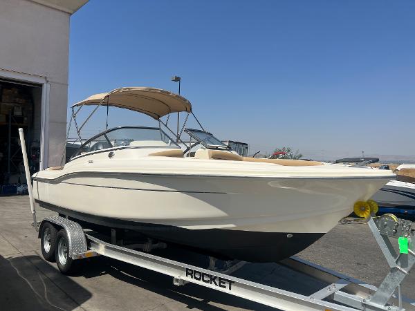 Scout 210 Dorado 2019 Scout 210 Dorado boat on a trailer in a marina.