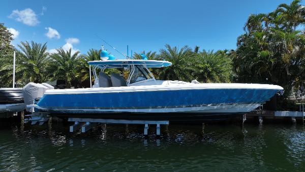 Intrepid 475 Panacea 2022 Intrepid 475 Panacea boat docked near palm trees.