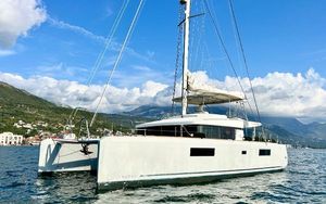 Lagoon 52 F 2021 Lagoon 52 F catamaran sailing on a scenic coastal waterway.