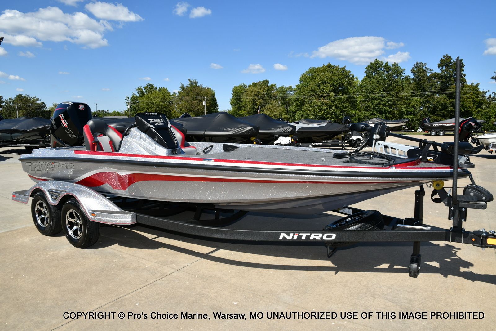 Nitro Z20 XL 2026 Nitro Z20 XL boat on trailer, silver and red design, parked outdoors.