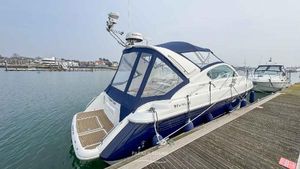 Fairline Targa 34 2002 Fairline Targa 34 yacht docked at a marina, featuring sleek design and blue canopy.