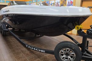 Tahoe T21 2025 Tahoe T21 boat on display with trailer in showroom.