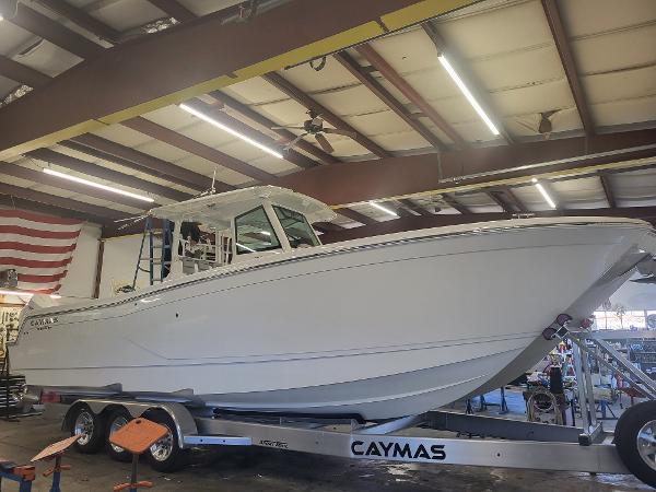 Caymas 34 CT 2024 Caymas 34 CT boat on trailer in a warehouse.