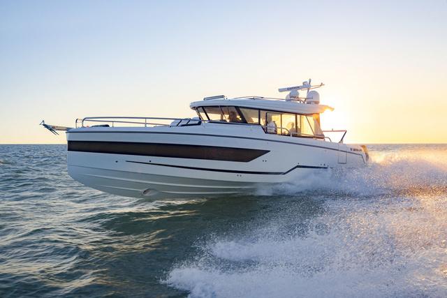 Wellcraft 38 Explorer 2024 Wellcraft 355 boat cruising on the ocean at sunset.
