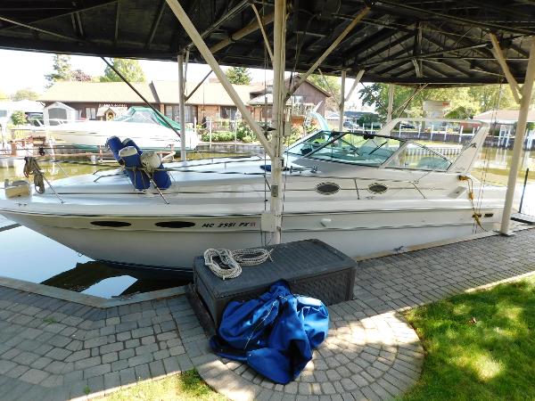 Sea Ray 330 Express Cruiser 1995 Sea Ray 330 Express Cruiser docked under a covered marina.