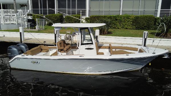 Sea Hunt Ultra 265 SE 2022 Sea Hunt Ultra 265 SE boat docked, featuring sleek design and dual engines.