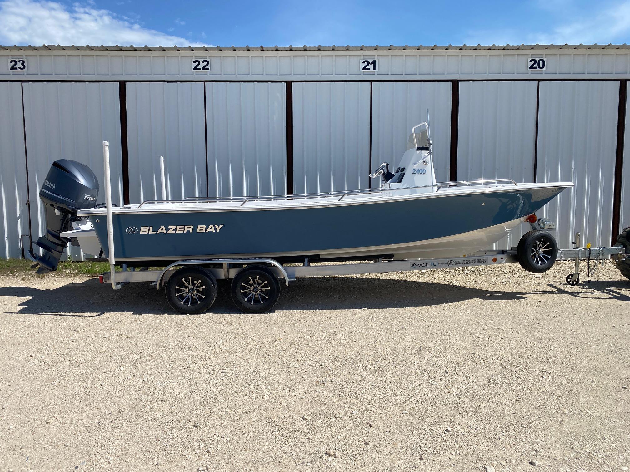 Blazer Bay 2400 Open Bay Striper 2026 Blazer Bay 2400 Open Bay Striper boat on trailer, parked outdoors.