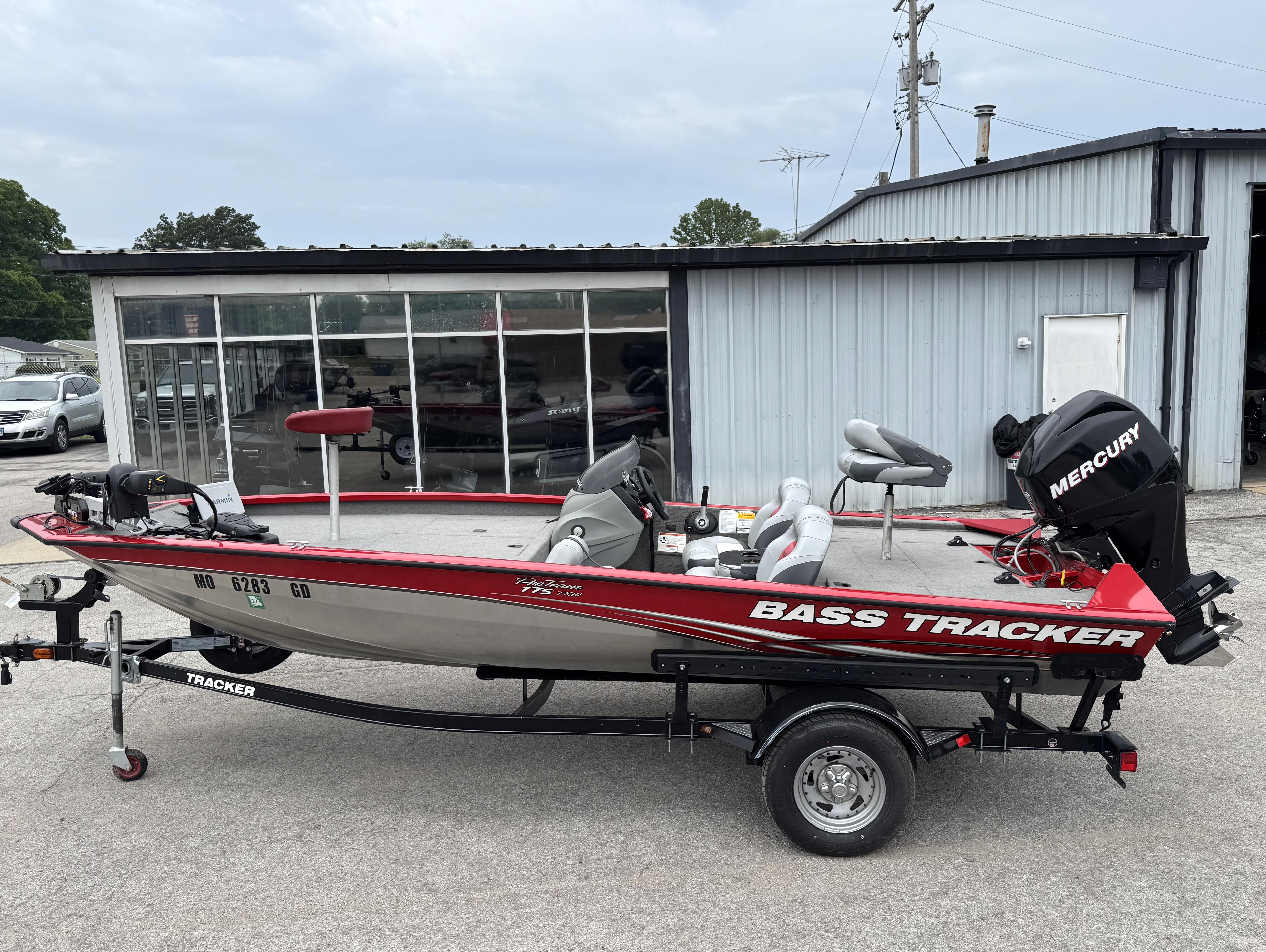 Tracker Pro Team 175 TXW 2012 Tracker Pro Team 175 TXW bass boat with Mercury engine, parked outside a building.