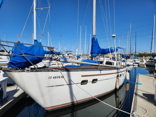 Custom King's Legend 41 1982 Custom King's Legend 41 sailboat docked in marina, blue covers, sunny day.