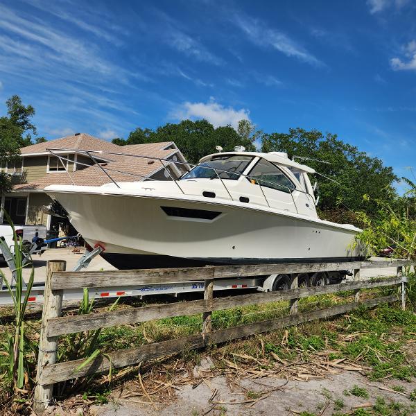 Pursuit OS 325 Offshore 2020 Pursuit OS 325 Offshore boat on a trailer in a residential area.