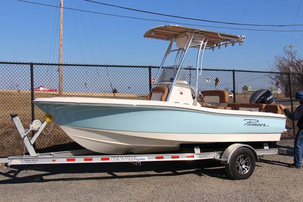 Pioneer 180 Islander 2025 Pioneer 180 Islander boat on trailer, light blue hull, parked outdoors.