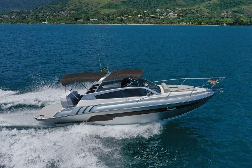Hanover 305 Inboard 2025 Hanover 305 Inboard boat cruising on blue ocean with scenic mountain backdrop.