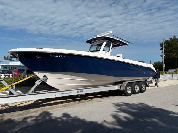 Everglades 325 Center Console 2012 Everglades 325 Center Console boat on a trailer, blue and white design, parked outdoors.