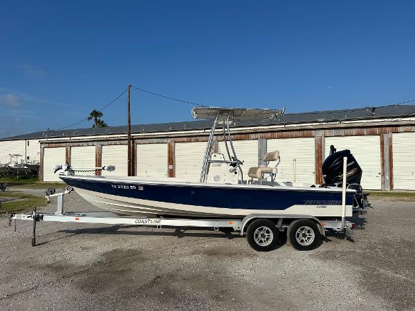 Pathfinder 2200-V 2010 Pathfinder 2200-V boat on trailer, parked outdoors near storage units.