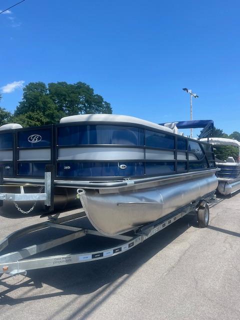 Bentley Pontoons Legacy Swingback 2026 Bentley Pontoons Legacy Swingback on trailer, blue and silver design, parked outdoors.