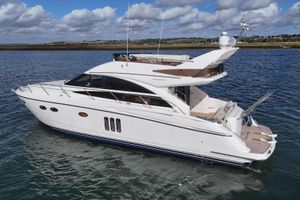 Princess 54 Flybridge Motor Yacht 2008 Princess 54 Flybridge yacht cruising on a calm sea under a partly cloudy sky.