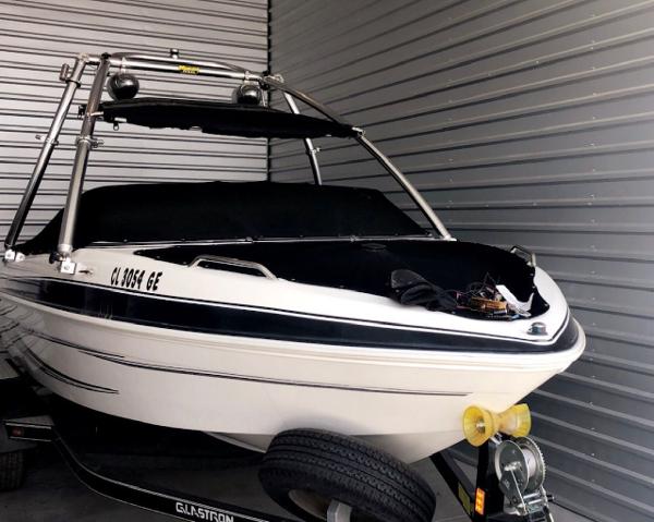Glastron GT 205 2009 Glastron GT 205 boat in storage, featuring sleek design and covered interior.