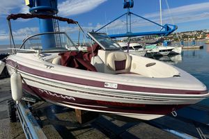 Tahoe Q4 SS 2009 Tahoe Q4 SS boat docked at marina with clear sky background.