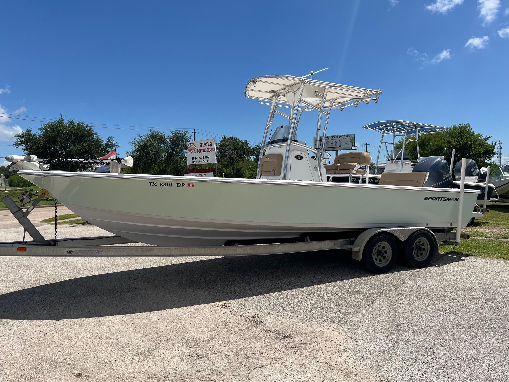 Sportsman Masters 247 Bay Boat 2015 Sportsman Masters 247 Bay Boat on trailer under clear blue sky.