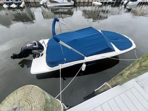 Sea Ray SPX 190 Outboard 2019 Sea Ray SPX 190 OB boat docked with blue cover, outboard motor visible.
