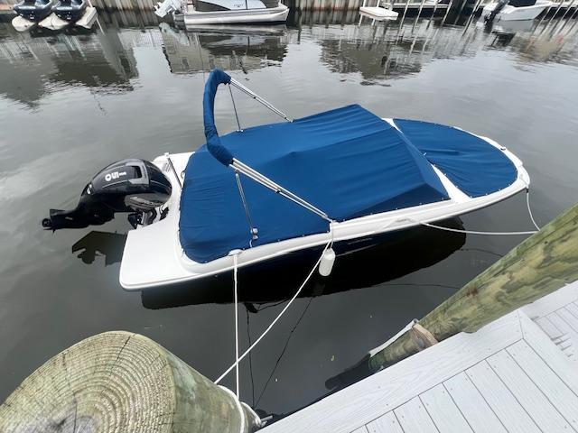 Sea Ray SPX 190 Outboard 2019 Sea Ray SPX 190 OB boat docked with blue cover, outboard motor visible.
