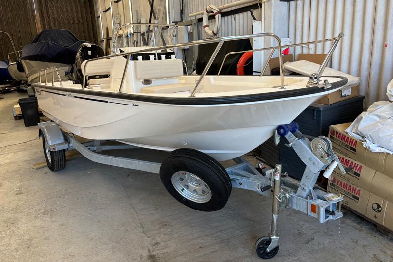 Boston Whaler 170 Montauk 2023 Boston Whaler 170 Montauk boat on trailer in storage facility.