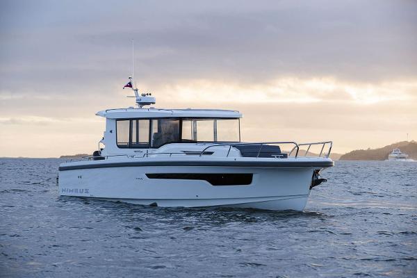 Nimbus C11 2025 Nimbus C11 boat cruising on calm waters at sunset.