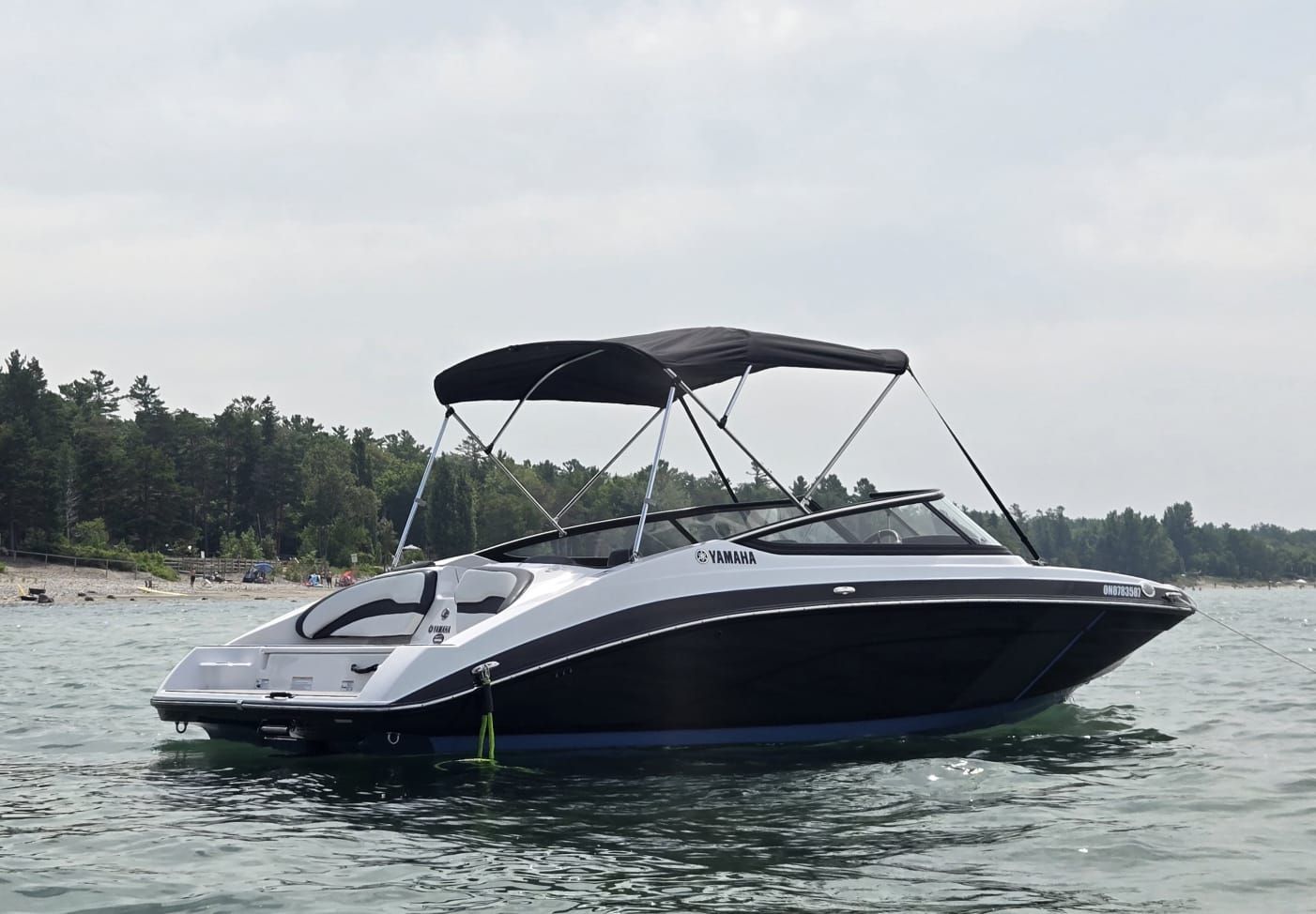 Yamaha Boats 195SX 2023 Yamaha Boats 195SX on water, featuring sleek design and canopy.