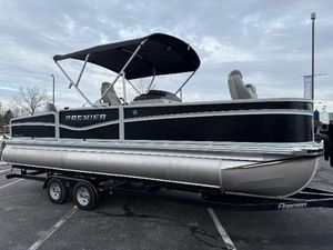 Premier 230 SunSation Angler 2025 Premier 230 SunSation Angler pontoon boat on trailer, parked outdoors.
